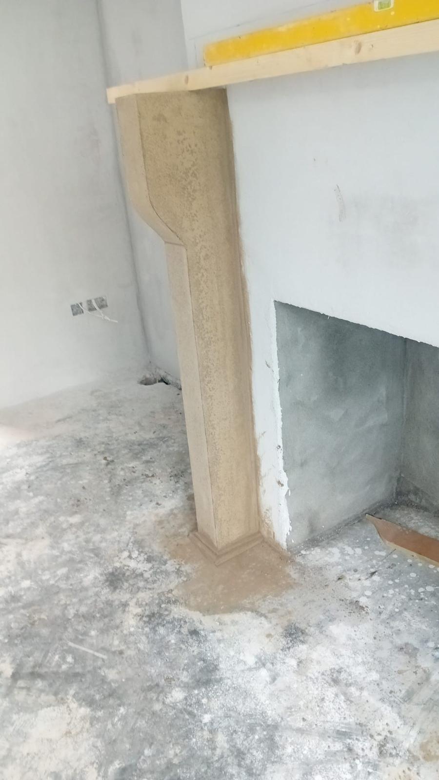 Bespoke fireplace corbel with elegant curved profile, hand-shaped on site