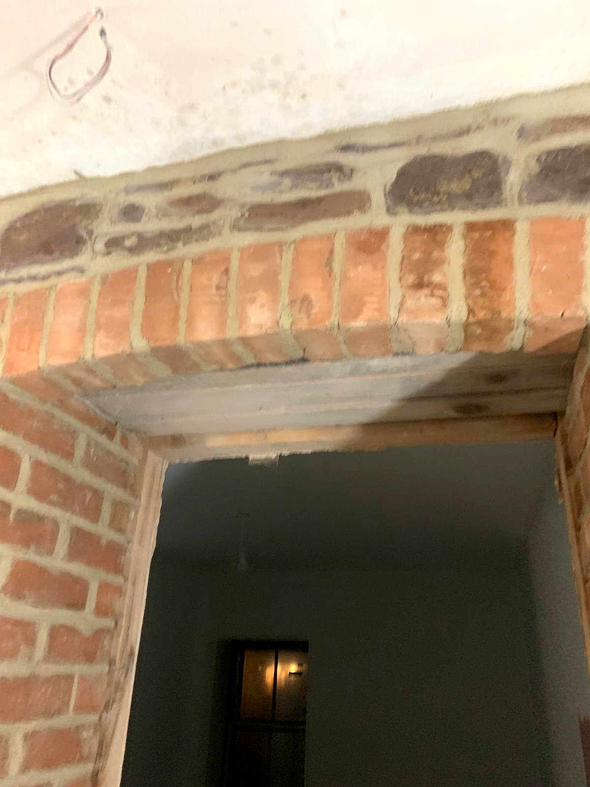 Interior brick pier with inset stone panels, freshly lime pointed