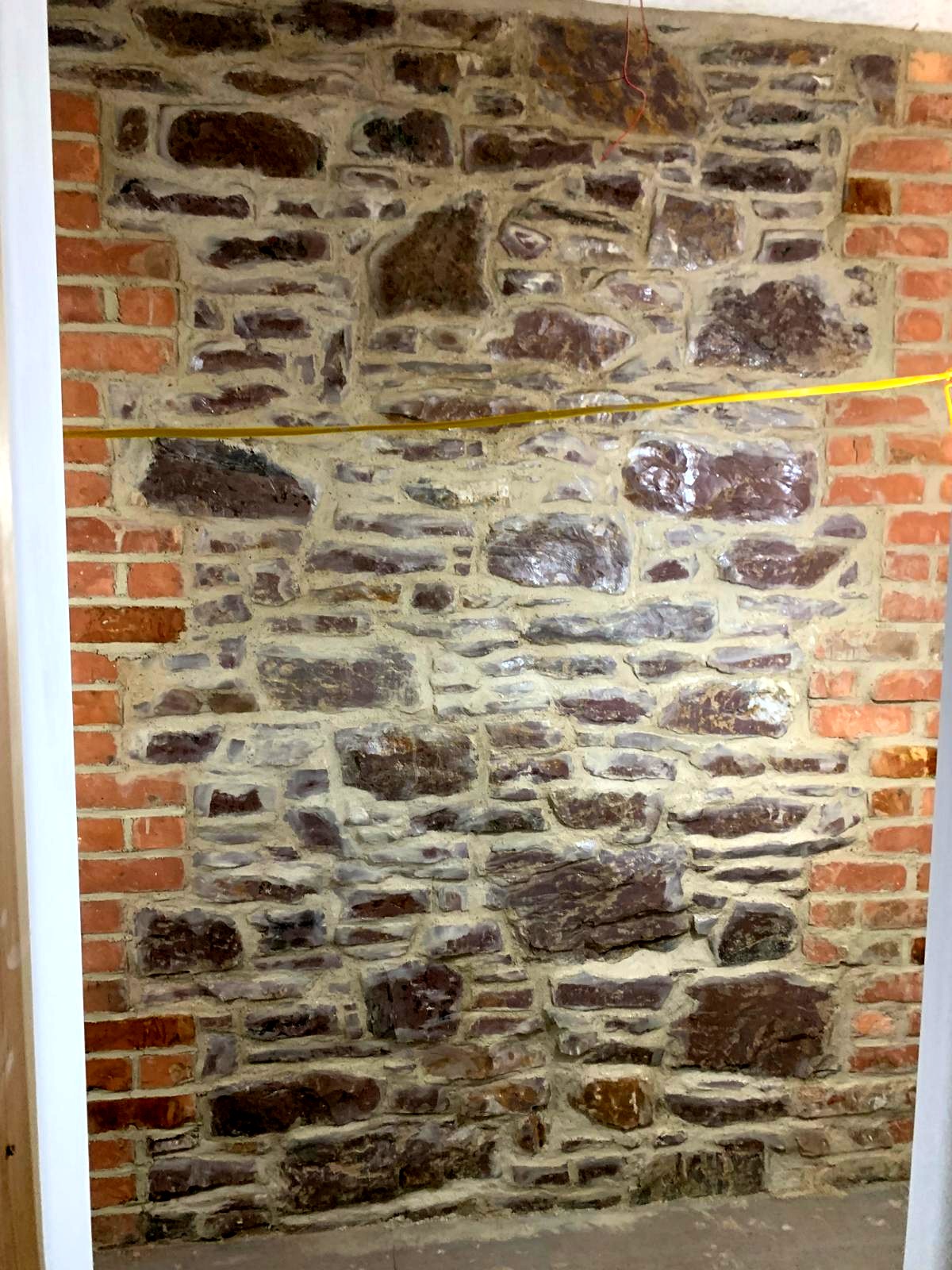 Exposed brick arch and stone above an internal doorway, lime pointed